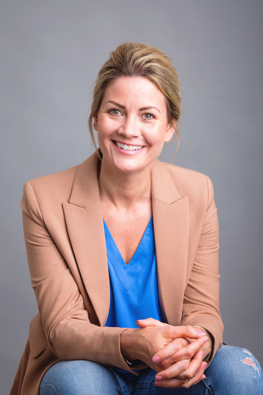 A portrait of woman man taken in a studio set up with backdrop and lighting equipment